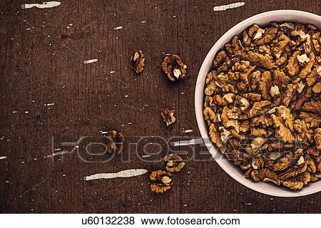 Stock Photo - Walnut kernels in ceramic bowl. Fotosearch