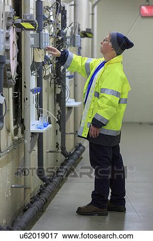 Water department engineer examining instrumentation panel. View Large Photo Image Stock Photo - Water department engineer examining instrumentation panel.. Fotosearch