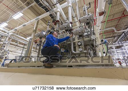 Stock Photo - Water department engineer standing in chemical treatment room.. Fotosearch