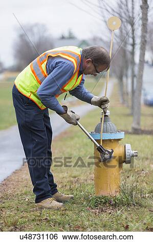 Water department technician installing a snow stake. View Large Photo Image Stock Photograph - Water department technician installing a snow stake.. Fotosearch