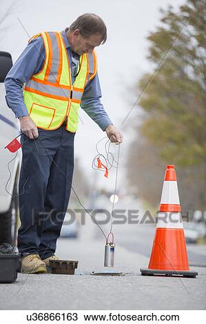 Water department technician using flow rate sensor. View Large Photo Image Stock Image - Water department technician using flow rate sensor.. Fotosearch