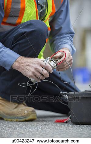 Stock Photo - Water department technician using flow rate sensor.. Fotosearch