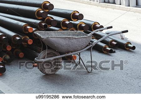 Stock Photograph - Wheelbarrow and heat pipes. Fotosearch