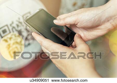 Woman scanning QR code with smartphone View Large Photo Image Stock Image - Woman scanning QR code with smartphone. Fotosearch