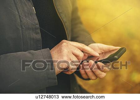 Woman using mobile phone outdoors View Large Photo Image Stock Image - Woman using mobile phone outdoors. Fotosearch
