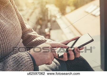 Stock Image - Woman using smartphone. Fotosearch