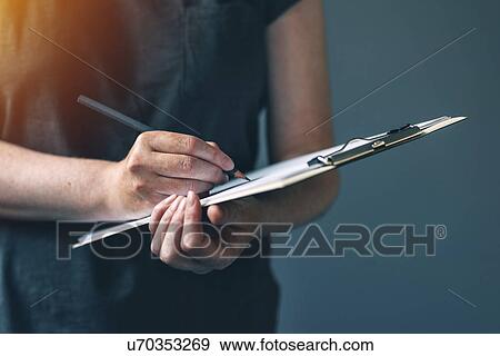 Stock Photo - Woman writing notes. Fotosearch