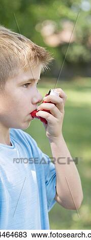 Stock Image - Young boy using an inhaler.. Fotosearch