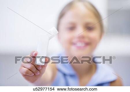 Young girl holding inhaler. View Large Photo Image Picture - Young girl holding inhaler.. Fotosearch