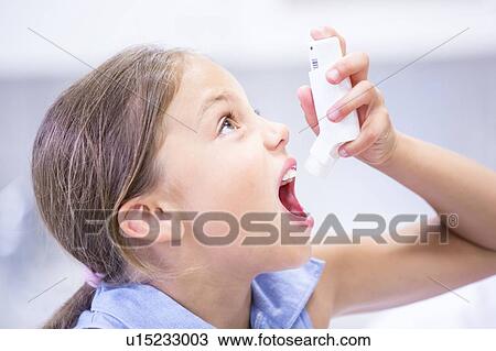 Young girl using inhaler. View Large Photo Image Stock Image - Young girl using inhaler.. Fotosearch