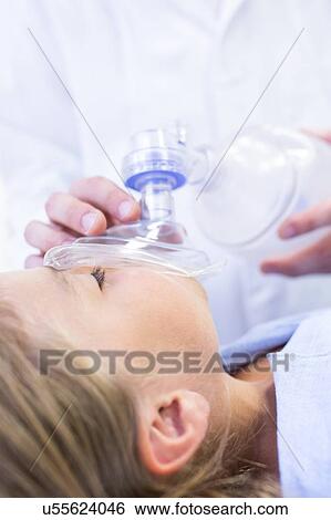 Stock Photograph - Young girl with mask covering mouth.. Fotosearch