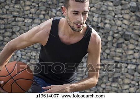 Young man holding basketball. View Large Photo Image Stock Photo - Young man holding basketball.. Fotosearch