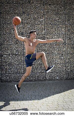 Young man jumping with basketball. View Large Photo Image Stock Photography - Young man jumping with basketball.. Fotosearch
