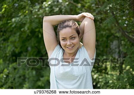 Young woman stretching before exercise. View Large Photo Image Stock Photo - Young woman stretching before exercise.. Fotosearch