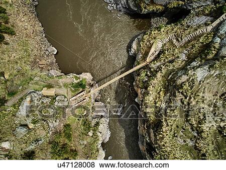 Aerial view of rope bridge crossing river, Huinchiri, Cusco, Peru View Large Photo Image Stock Photo - Aerial view of rope bridge crossing river, Huinchiri, Cusco, Peru. Fotosearch