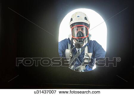 Stock Photo - Apprentice engineer in enclosed space fire training. Fotosearch