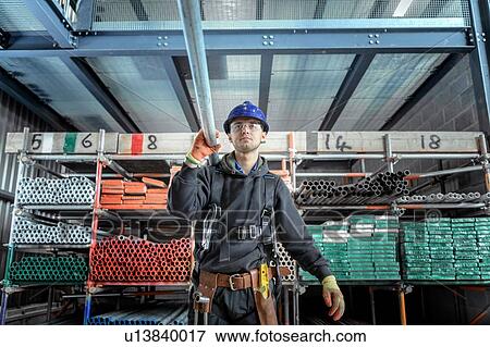 Apprentice engineer preparing and setting up scaffolding View Large Photo Image Stock Photo - Apprentice engineer preparing and setting up scaffolding. Fotosearch