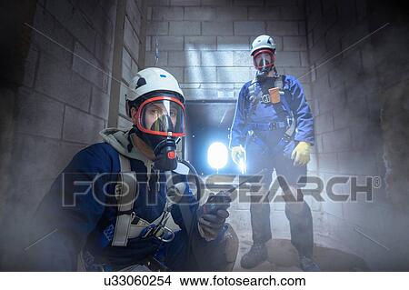 Apprentice engineers in enclosed space fire training View Large Photo Image Picture - Apprentice engineers in enclosed space fire training. Fotosearch