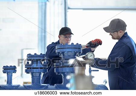 Apprentice engineers working on pipework View Large Photo Image Stock Image - Apprentice engineers working on pipework. Fotosearch