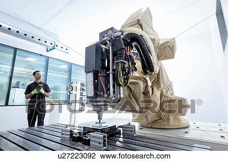 Apprentice robotics engineer with robot in robotics research facility View Large Photo Image Stock Image - Apprentice robotics engineer with robot in robotics research facility. Fotosearch