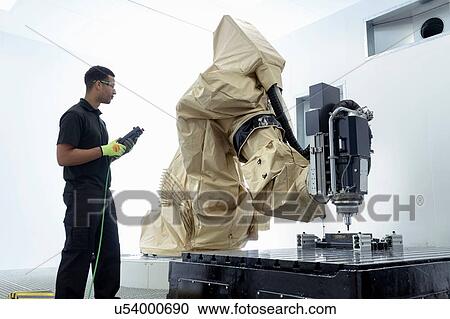 Apprentice robotics engineer with robot in robotics research facility View Large Photo Image Stock Image - Apprentice robotics engineer with robot in robotics research facility. Fotosearch