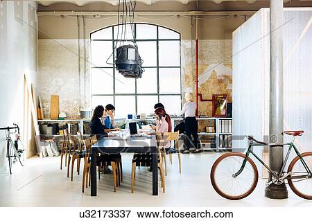 Stock Photo - Architects at brainstorming meeting. Fotosearch