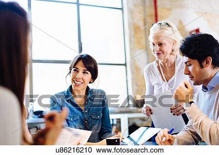 Architects going through documents together View Large Photo Image Stock Image - Architects going through documents together. Fotosearch
