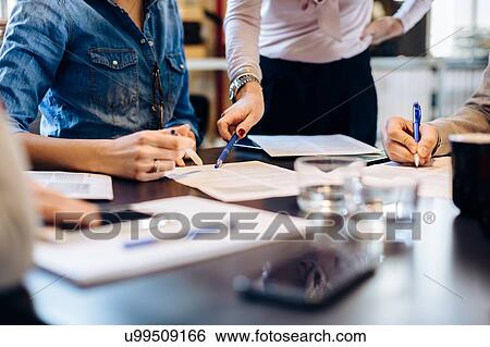 Architects going through documents together View Large Photo Image Stock Photograph - Architects going through documents together. Fotosearch