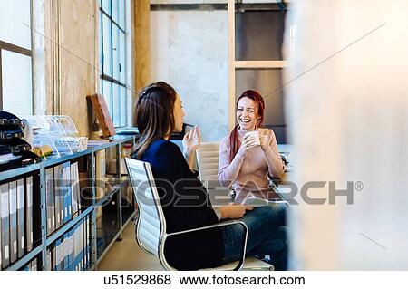 Stock Photo - Architects having coffee break by filing shelves. Fotosearch