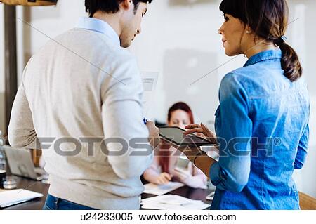 Stock Photography - Architects having discussion using digital tablet. Fotosearch