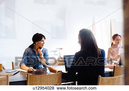 Stock Photo - Architects working at meeting table. Fotosearch