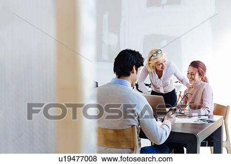 Architects working at meeting table View Large Photo Image Stock Photo - Architects working at meeting table. Fotosearch