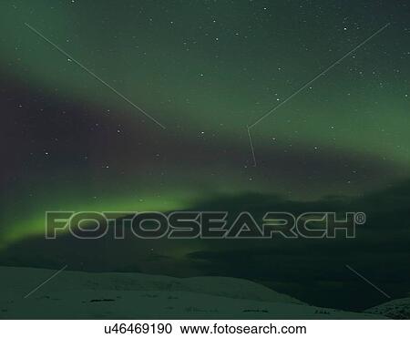 Aurora borealis over snow covered landscape at night, Finnmark, Norway View Large Photo Image Stock Image - Aurora borealis over snow covered landscape at night, Finnmark, Norway. Fotosearch