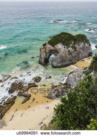 Stock Image - Australia, New South Wales, Bermagui, Rock formation in sea. Fotosearch