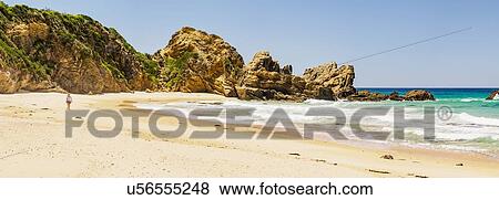 Australia, New South Wales, Bermagui, Woman walking along beach View Large Photo Image Stock Photo - Australia, New South Wales, Bermagui, Woman walking along beach. Fotosearch