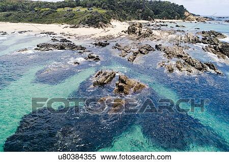 Australia, New South Wales, Bermagui, Sharp rocks in water nera beach View Large Photo Image Stock Photography - Australia, New South Wales, Bermagui, Sharp rocks in water nera beach. Fotosearch