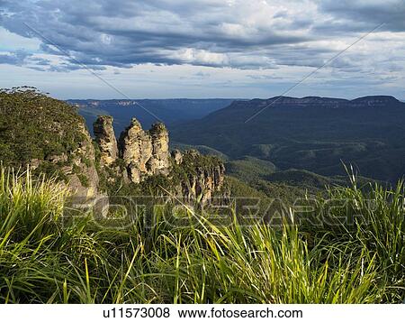 Stock Photo - Australia, New South Wales, Blue Mountains, Landscape of Three Sisters and mountain range in background. Fotosearch