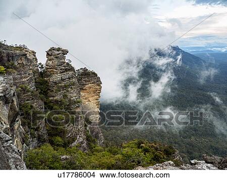 Picture - Australia, New South Wales, Katoomba, Large rocks and mountains in clouds. Fotosearch