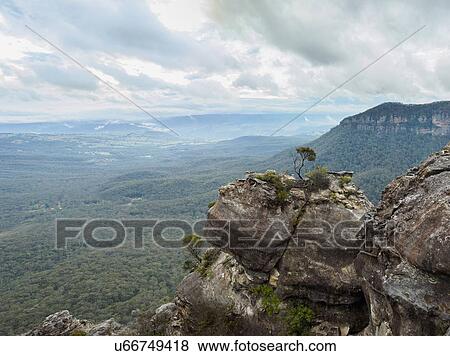 Stock Photo - Australia, New South Wales, Katoomba, Vast valley surrounded by high rocks. Fotosearch