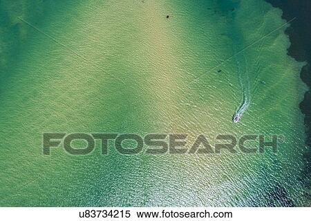 Stock Photography - Australia, New South Wales, Narooma, Aerial view of bay and motorboat. Fotosearch