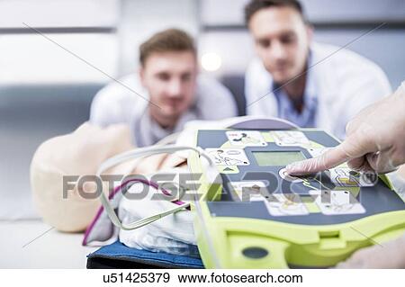 Stock Photo - Automated external defibrillator training.. Fotosearch