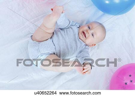 Baby boy lying on back. View Large Photo Image Picture - Baby boy lying on back.. Fotosearch
