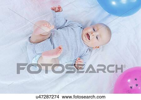 Picture - Baby boy lying on back.. Fotosearch