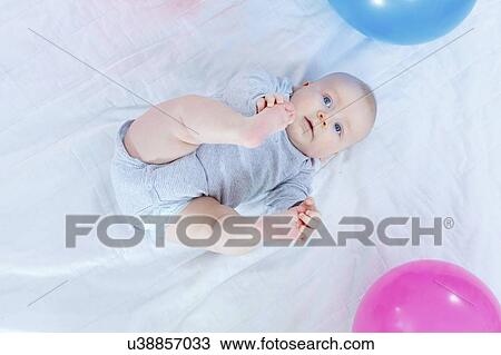 Stock Image - Baby boy lying on back.. Fotosearch