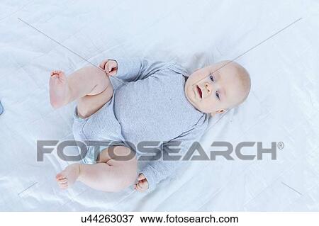 Baby boy lying on back. View Large Photo Image Stock Photo - Baby boy lying on back.. Fotosearch