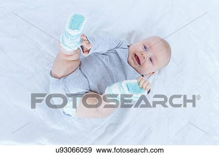 Stock Photo - Baby boy lying on back.. Fotosearch