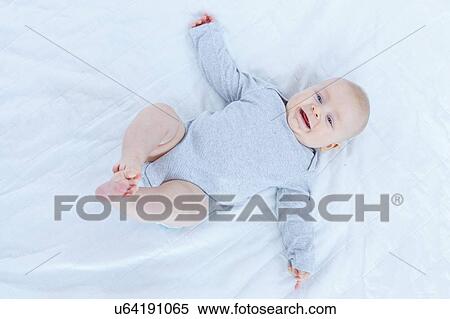 Baby boy lying on back. View Large Photo Image Stock Photography - Baby boy lying on back.. Fotosearch