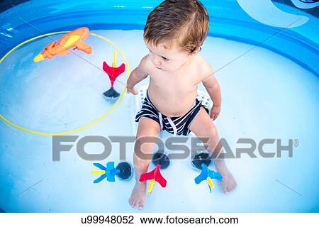 Baby boy sitting in paddling pool View Large Photo Image Stock Image - Baby boy sitting in paddling pool. Fotosearch