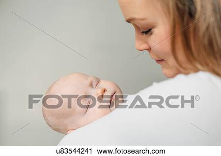 Baby girl sleeping in mother arms View Large Photo Image Stock Image - Baby girl sleeping in mother arms. Fotosearch