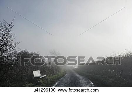 Stock Image - Bench beside country road, Houghton-le-Spring, Sunderland, UK. Fotosearch